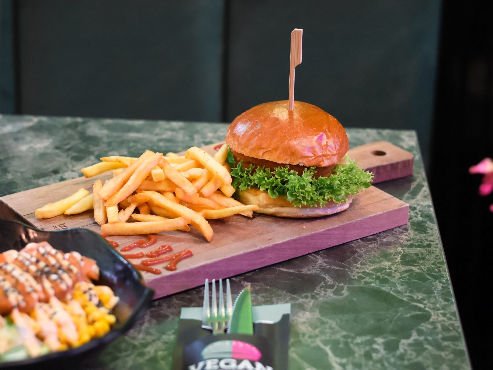 Burger and fries on a serving board