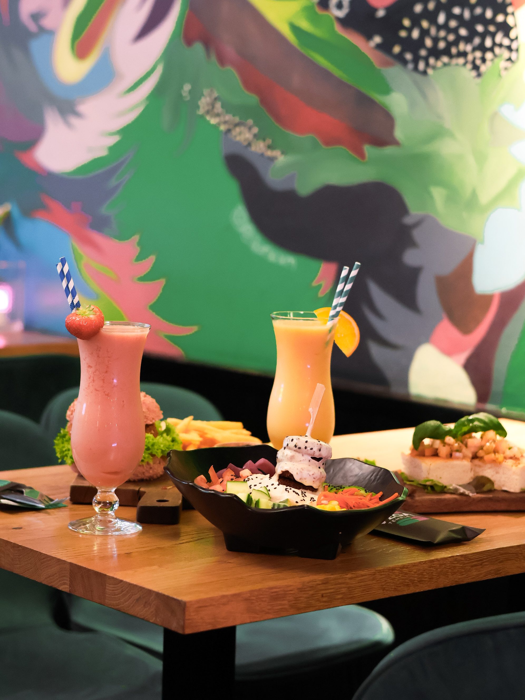 Smoothies and food under the mural